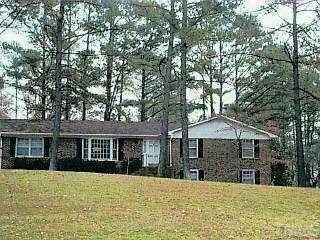2400 Pearces Road Zebulon, NC 27597 - Photo 1 of 1 a front view of a house with a yard