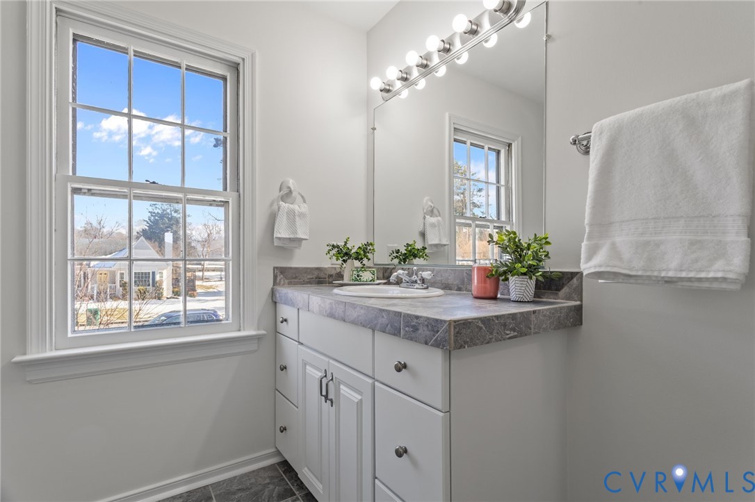 1316 Ware Road Henrico, VA 23229 - Photo 32 of 51 a bathroom with a granite countertop sink a mirror and a potted plant