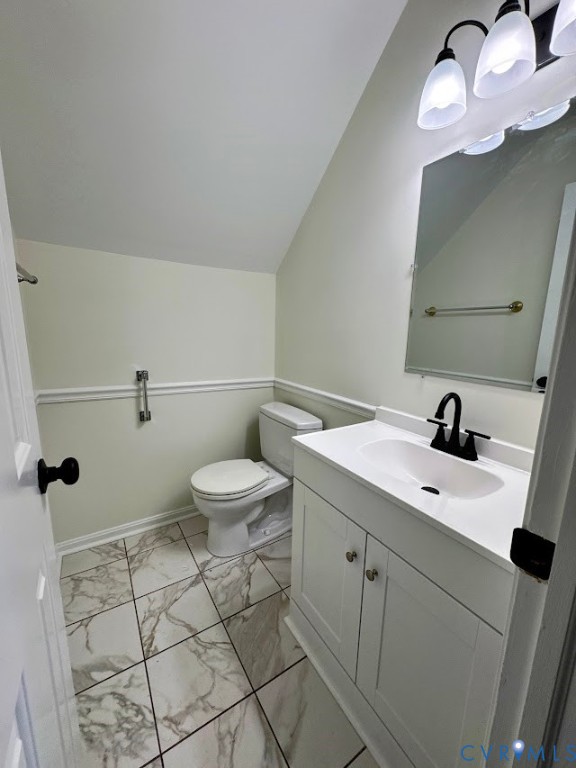 1316 Ware Road Henrico, VA 23229 - Photo 5 of 19 Half bath featuring vanity, lofted ceiling, and li