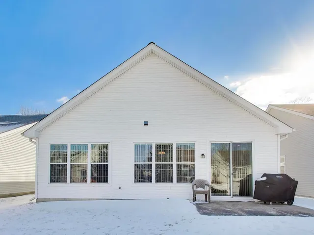 a view of a house with snow on the road
