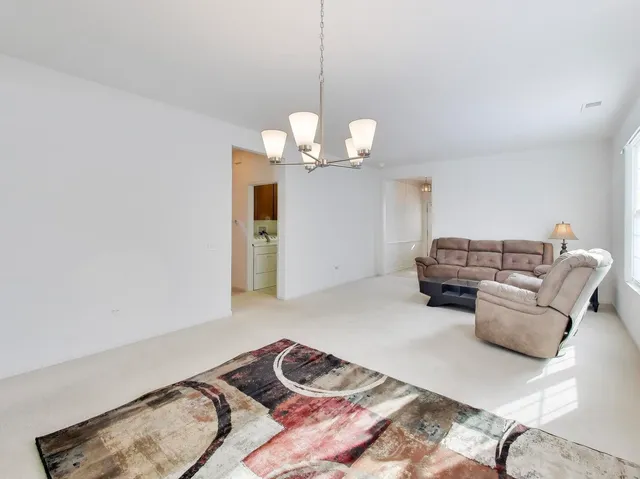 a kitchen with stainless steel appliances a sink a stove a center island and a refrigerator