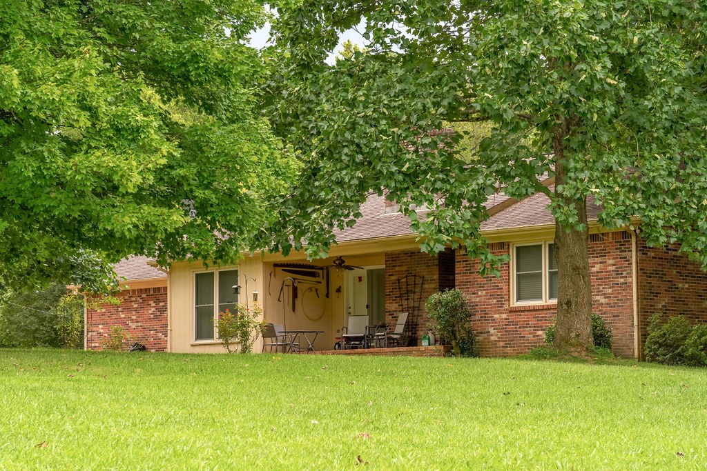 6299 New Chapel Road Springfield, TN 37172 - Photo 8 of 29 a front view of a house with a garden and trees