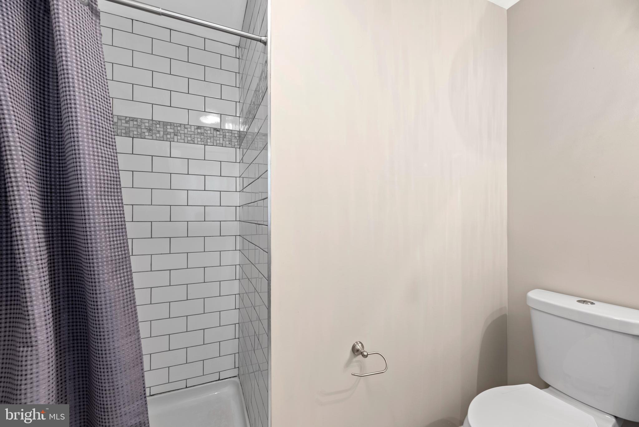 5756 Stephen Reid Road Huntingtown, MD 20639 - Photo 25 of 42 a white toilet sitting next to a shower