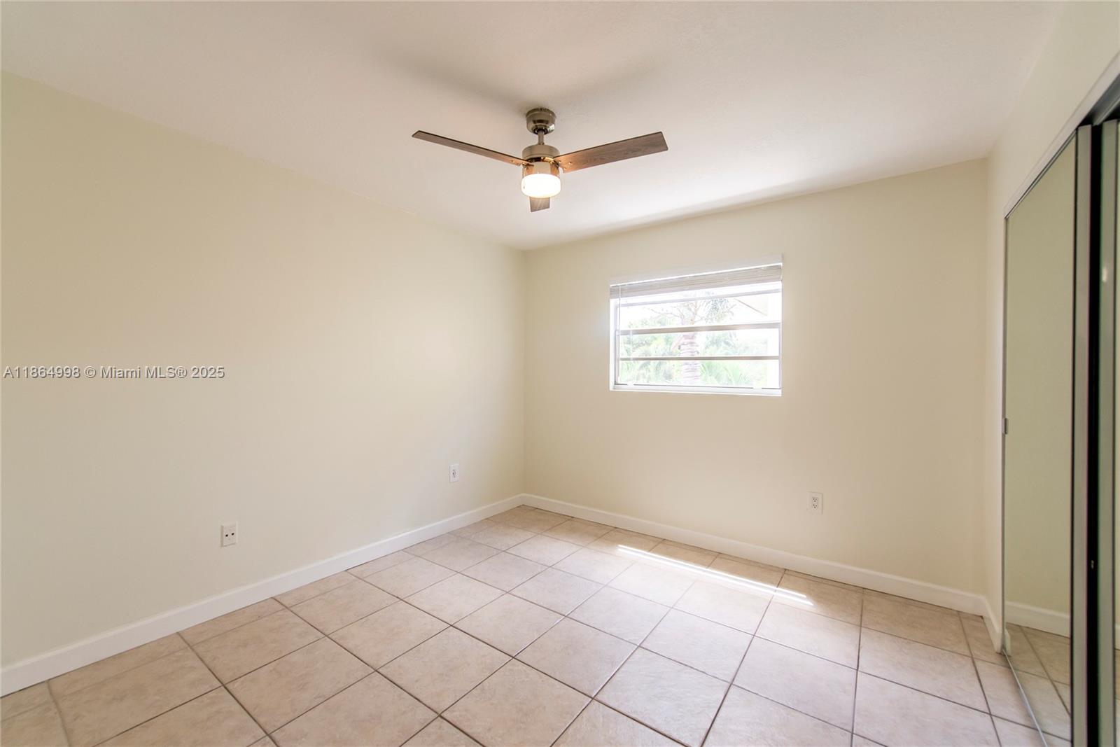 4600 Southwest 67th Avenue, Unit 237 Miami, FL 33155 - Photo 12 of 18 an empty room with windows and fan