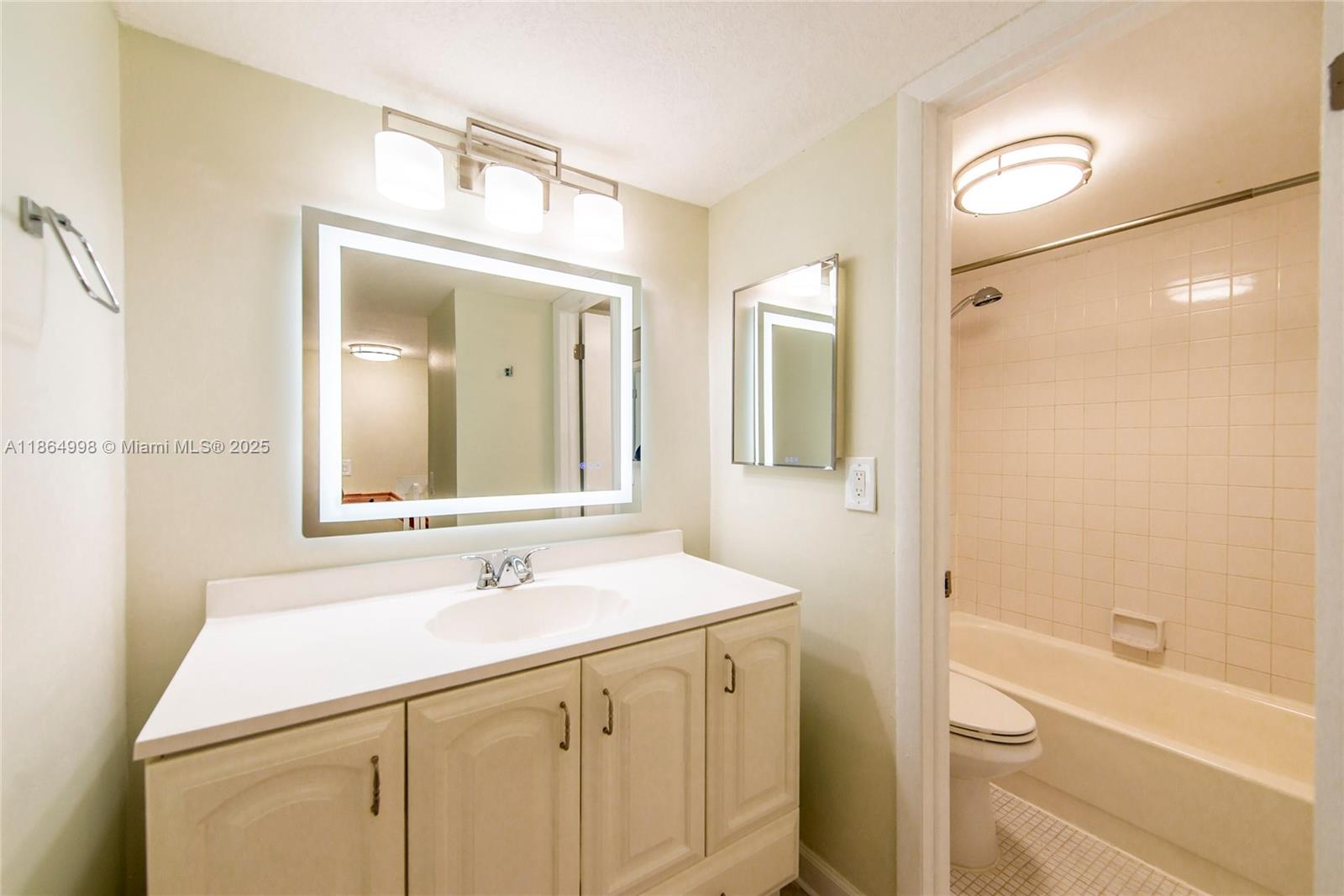 4600 Southwest 67th Avenue, Unit 237 Miami, FL 33155 - Photo 15 of 18 a bathroom with a sink a toilet and shower