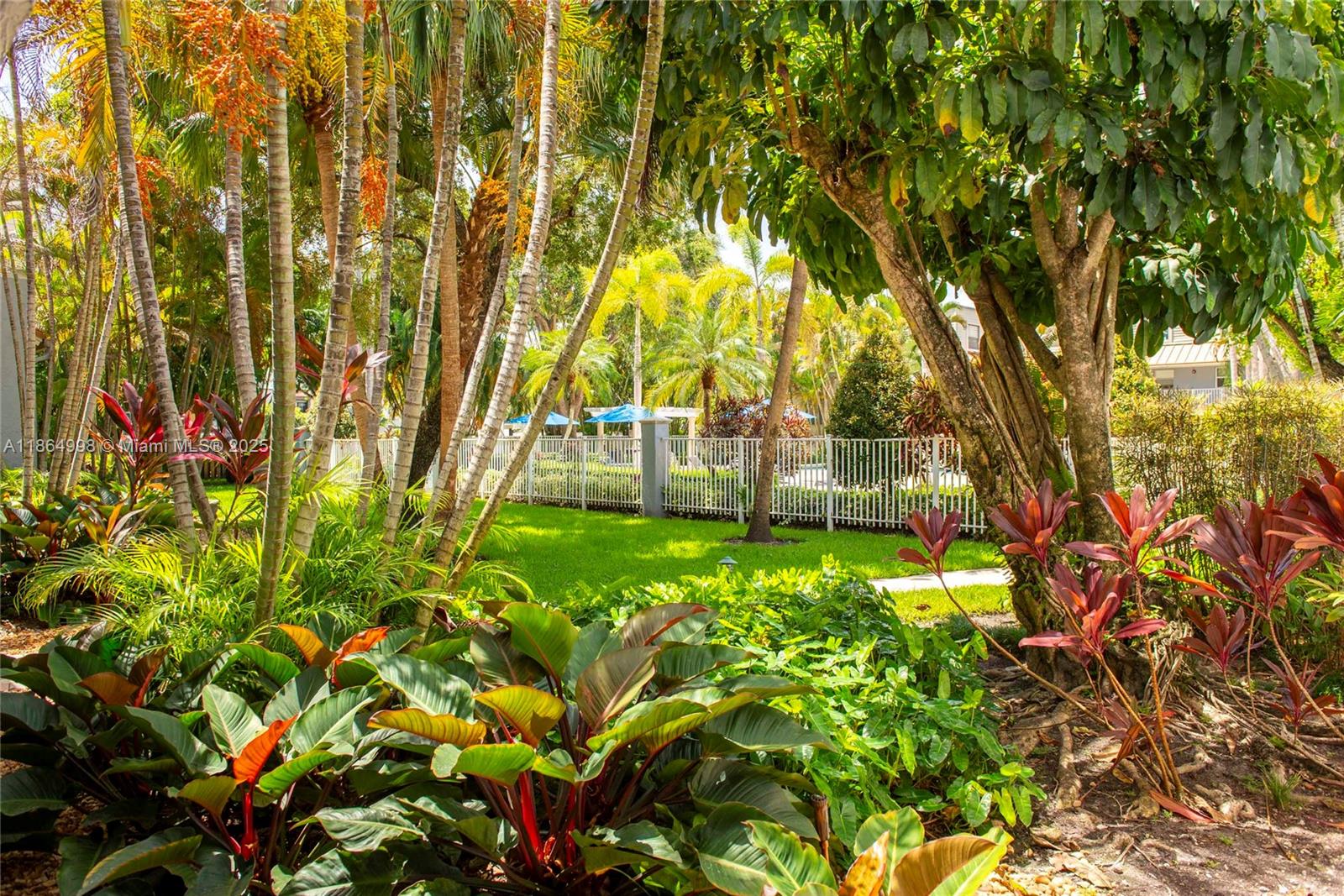 4600 Southwest 67th Avenue, Unit 237 Miami, FL 33155 - Photo 18 of 18 a backyard of a building with lawn chairs