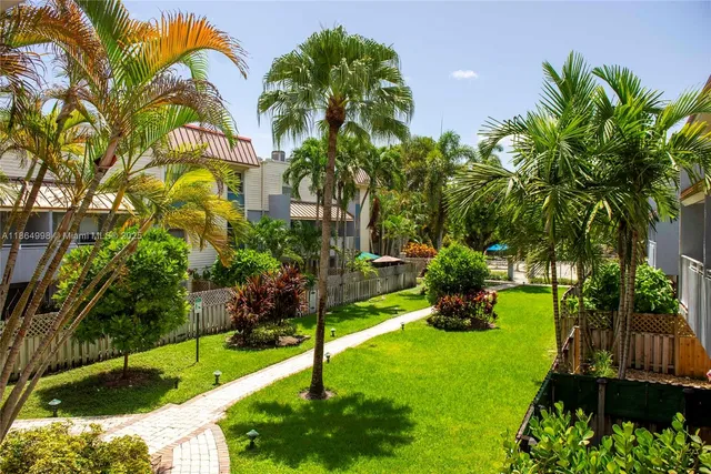 a big yard with swimming pool and trees