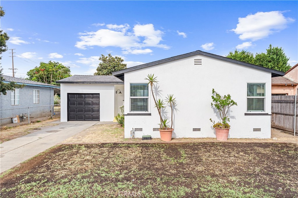 2234 South Standard Avenue Santa Ana, CA 92707 - Photo 1 of 30 a view of a white house with a potted plant
