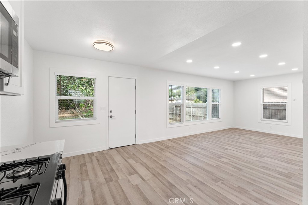 2234 South Standard Avenue Santa Ana, CA 92707 - Photo 21 of 30 a view of an empty room with wooden floor and a window