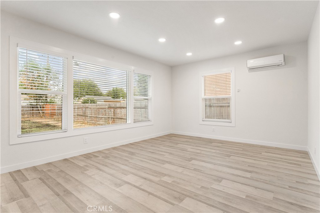 2234 South Standard Avenue Santa Ana, CA 92707 - Photo 6 of 30 a view of an empty room with wooden floor and a window