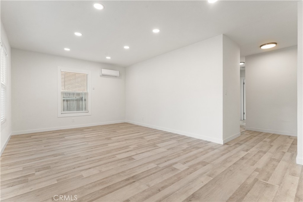 2234 South Standard Avenue Santa Ana, CA 92707 - Photo 7 of 30 a view of an empty room with wooden floor and a window