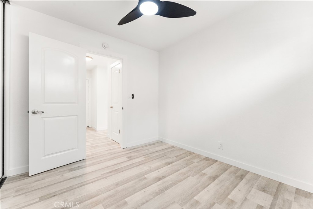 2234 South Standard Avenue Santa Ana, CA 92707 - Photo 10 of 30 an empty room with wooden floor and windows