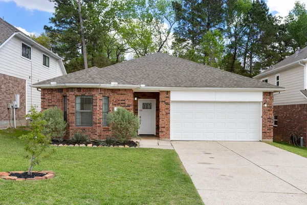 a front view of house with a garden