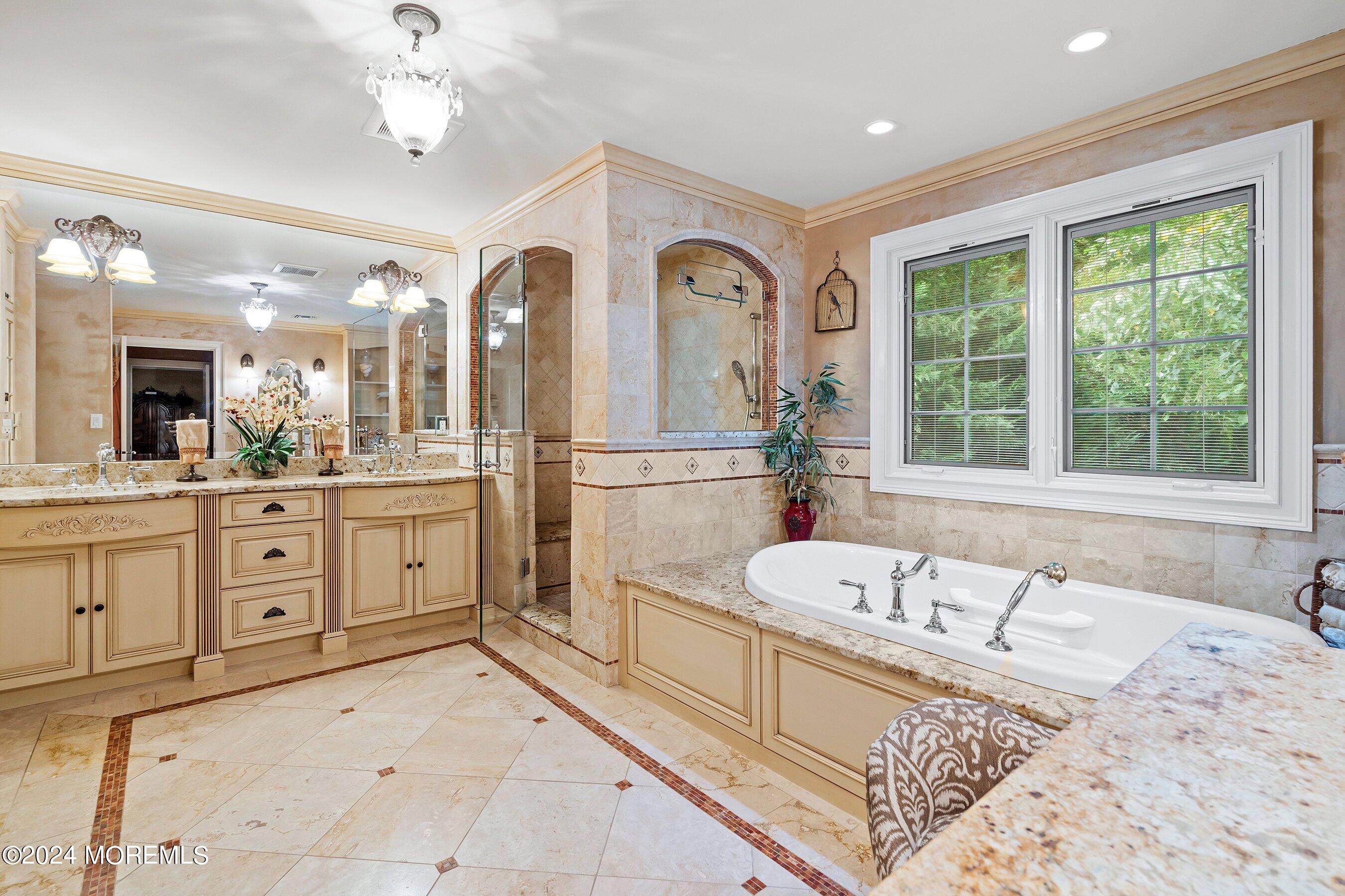 15 Doherty Drive Middletown, NJ 07748 - Photo 34 of 55 a spacious bathroom with a granite countertop tub sink and mirror