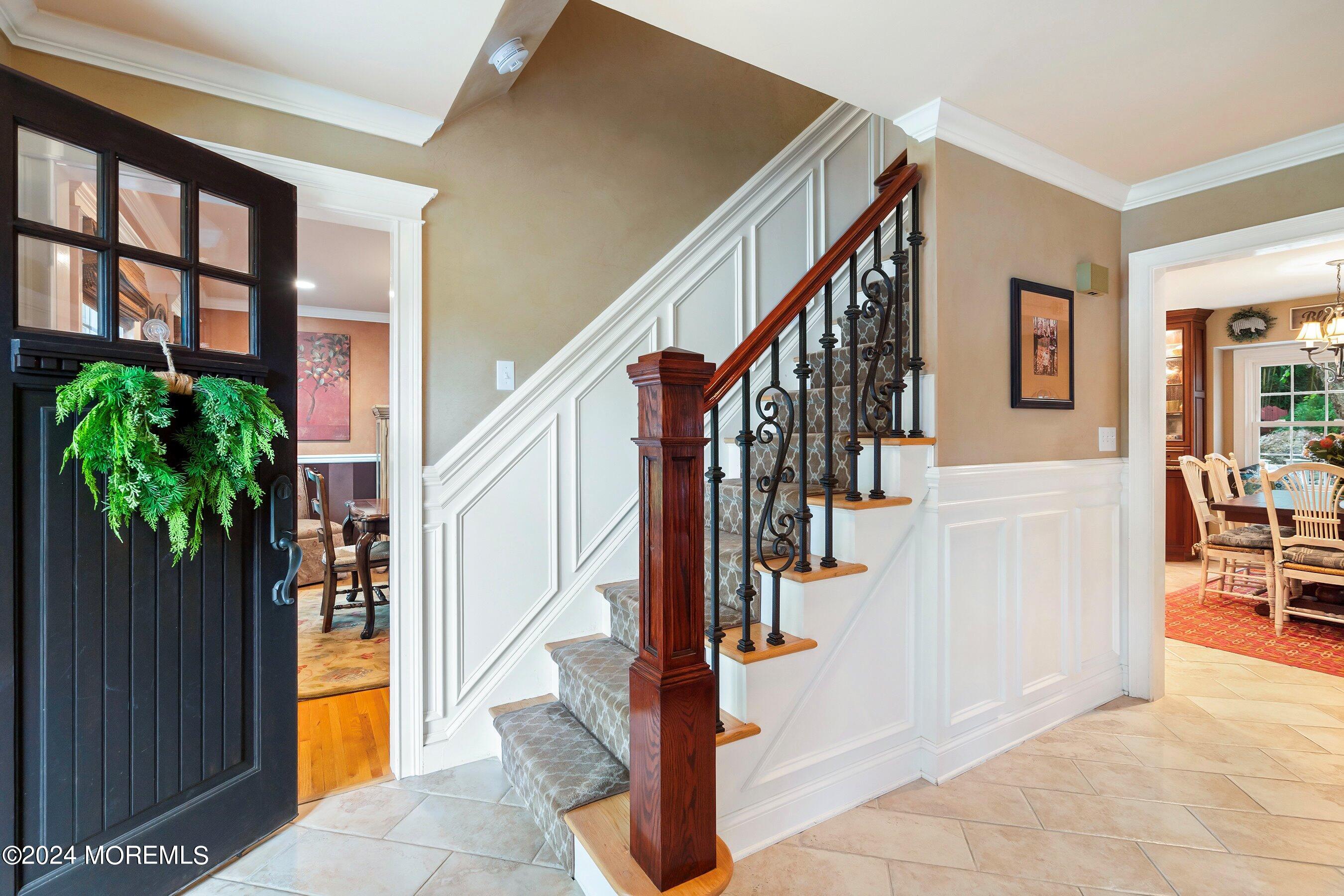 15 Doherty Drive Middletown, NJ 07748 - Photo 8 of 55 a view of staircase with lots of frames and a potted plant