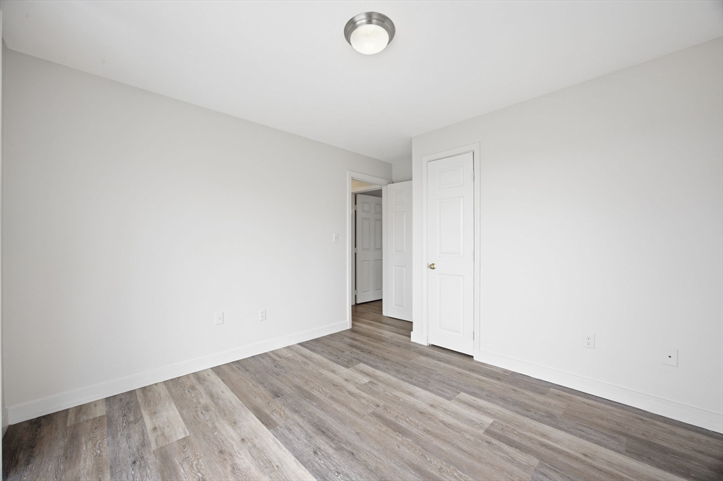 192 Swifts Beach Road Wareham, MA 02571 - Photo 36 of 38 a view of an empty room with wooden floor