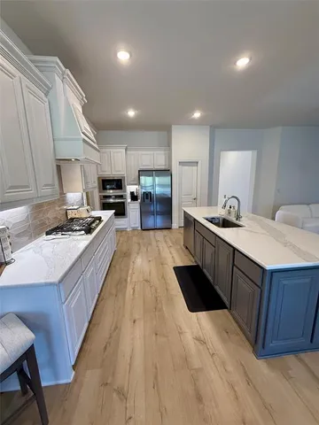 a kitchen with kitchen island a table and chairs