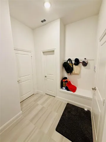 a bathroom with a sink a toilet a mirror and shower curtain