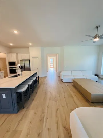 a living room with stainless steel appliances kitchen island granite countertop furniture and a kitchen view