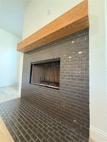 a living room with furniture fireplace and a window