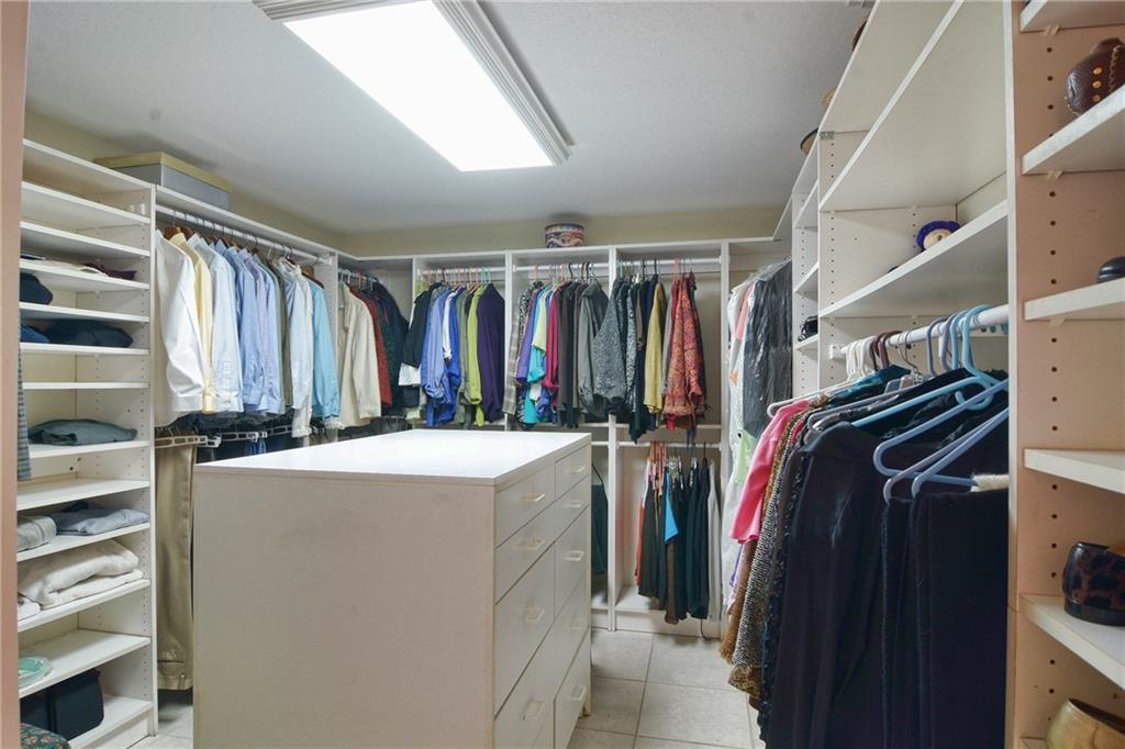 11 North River Road Stuart, FL 34996 - Photo 15 of 31 a view of walk in closet with clothes and shoes