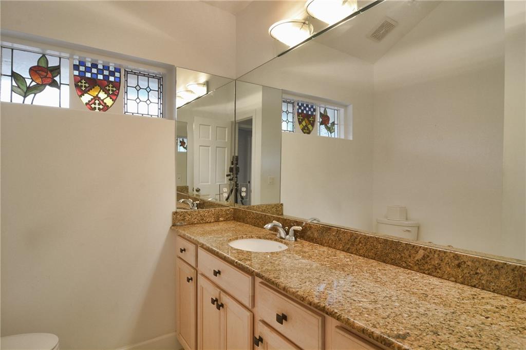 11 North River Road Stuart, FL 34996 - Photo 16 of 31 a bathroom with a granite countertop sink a large mirror and a shower