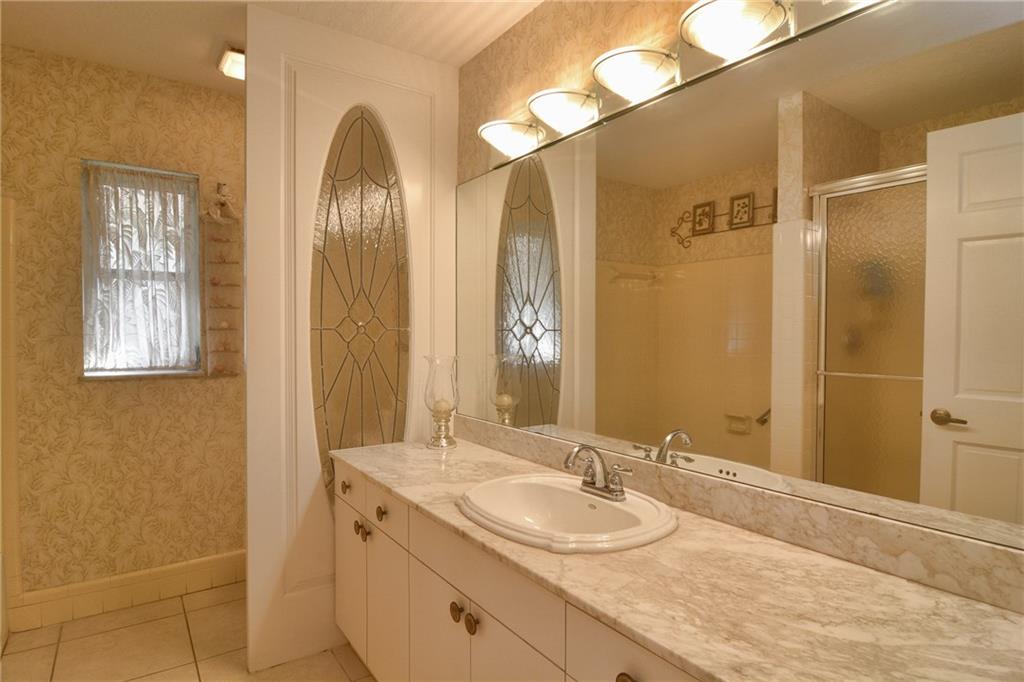 11 North River Road Stuart, FL 34996 - Photo 19 of 31 a bathroom with a double vanity sink and a mirror