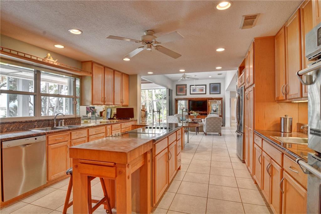 11 North River Road Stuart, FL 34996 - Photo 8 of 31 a kitchen with stainless steel appliances granite countertop a sink and cabinets