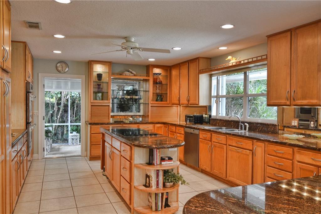 11 North River Road Stuart, FL 34996 - Photo 9 of 31 a kitchen with stainless steel appliances granite countertop a stove a sink and a refrigerator