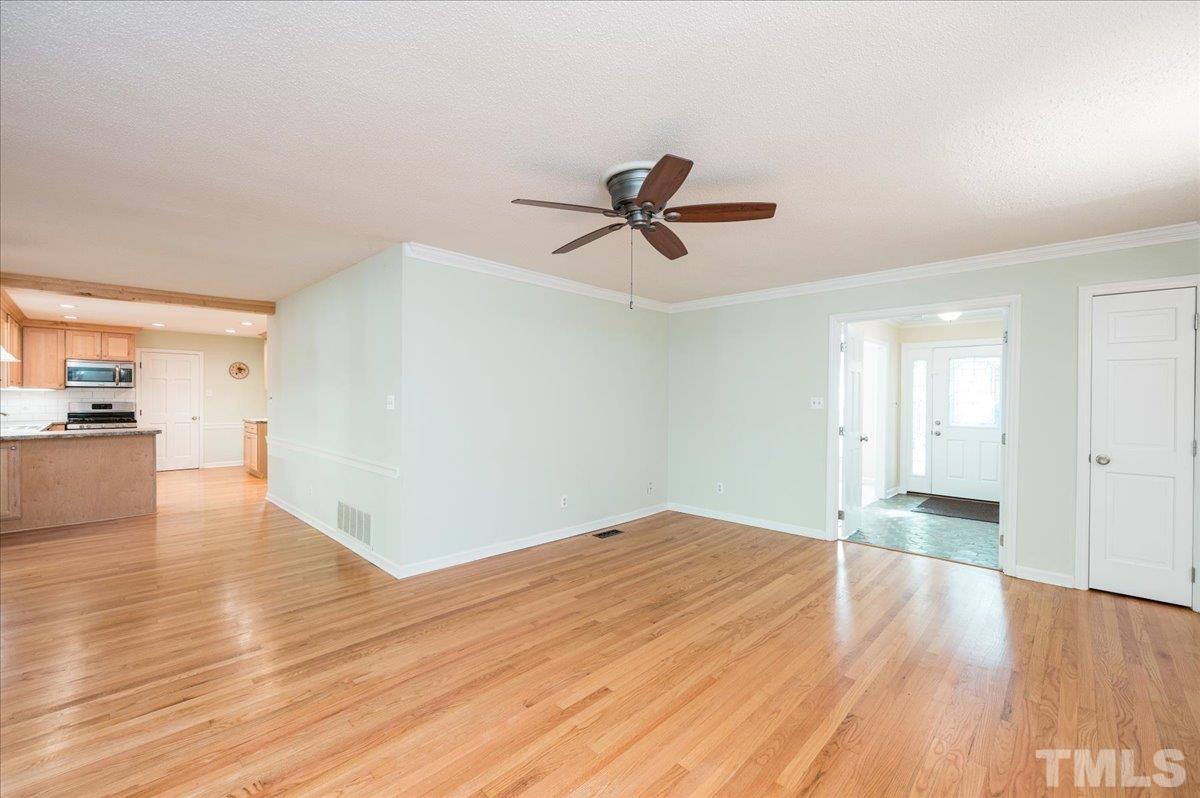 104 Dabney Road Cary, NC 27511 - Photo 20 of 35 a view of empty room with wooden floor and ceiling fan