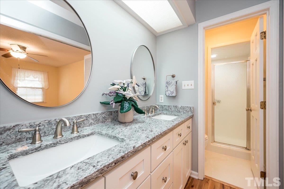 104 Dabney Road Cary, NC 27511 - Photo 24 of 35 a bathroom with a granite countertop sink and a mirror
