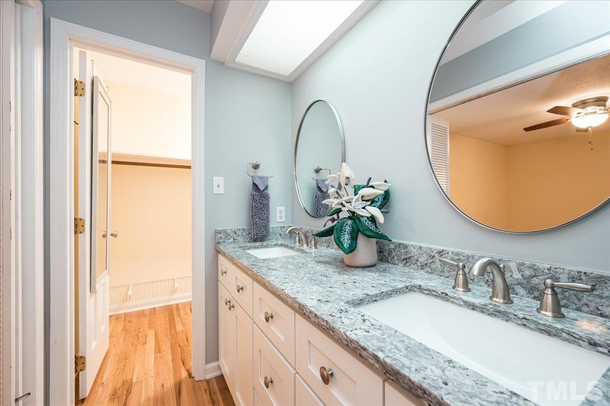 104 Dabney Road Cary, NC 27511 - Photo 25 of 35 a bathroom with a granite countertop sink and a mirror