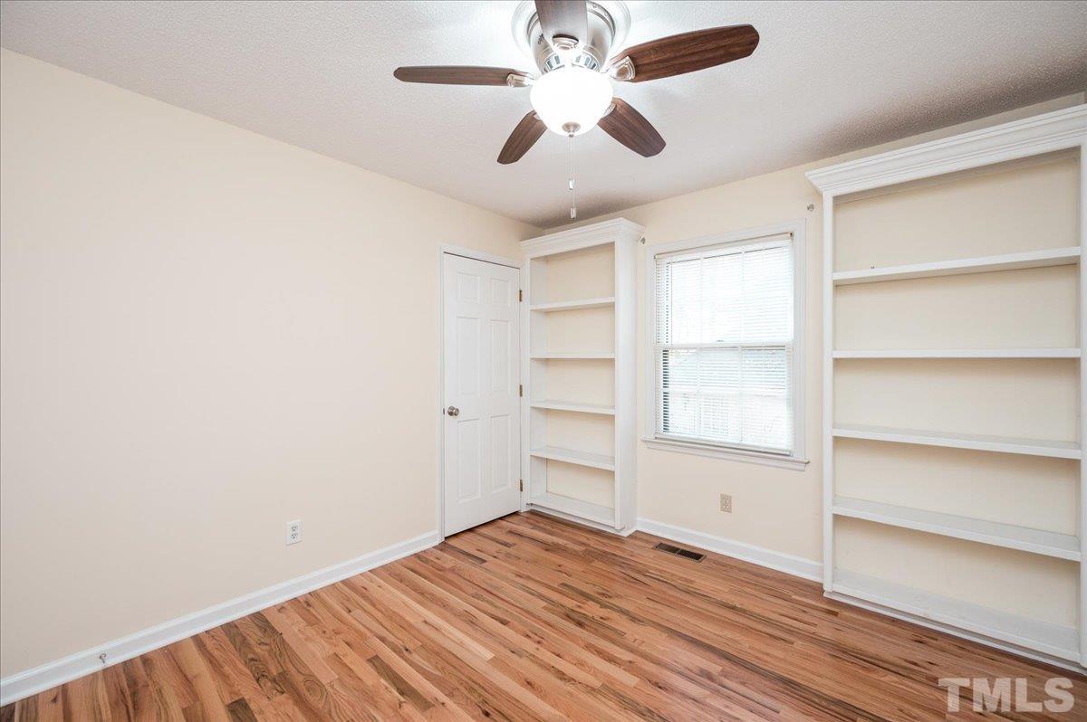 104 Dabney Road Cary, NC 27511 - Photo 27 of 35 a view of empty room with wooden floor and fan