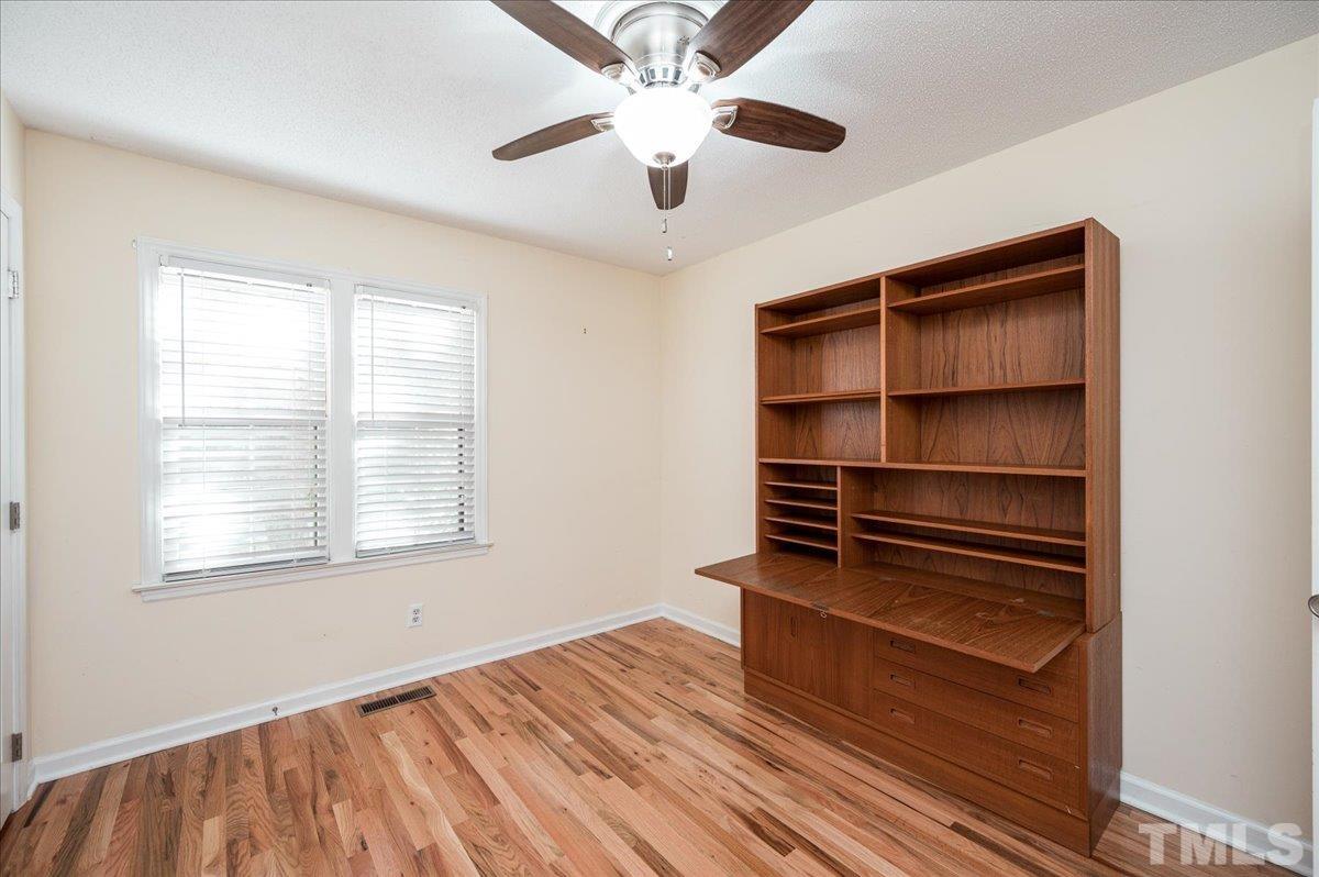 104 Dabney Road Cary, NC 27511 - Photo 29 of 35 a view of an empty room with a window and wooden floor