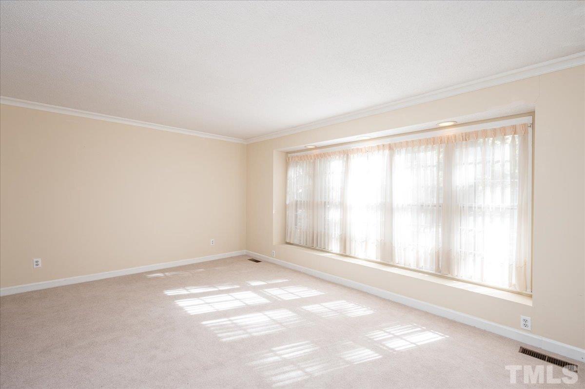104 Dabney Road Cary, NC 27511 - Photo 6 of 35 a view of an empty room with a window