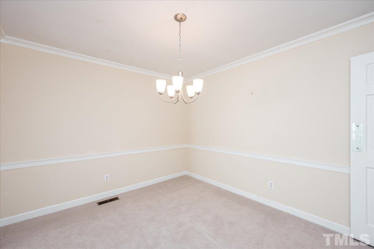 104 Dabney Road Cary, NC 27511 - Photo 9 of 35 a view of an empty room with chandelier fan