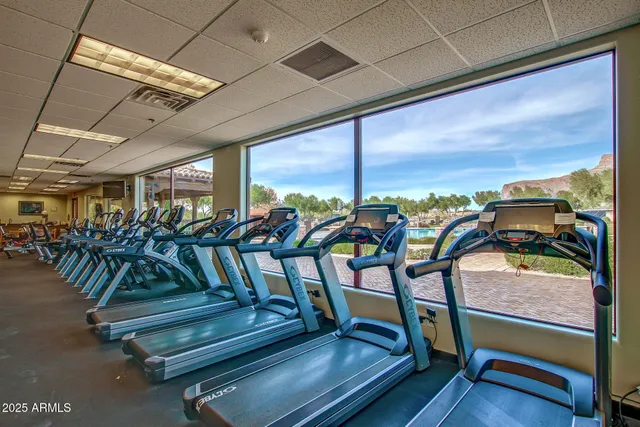 a view of a patio with a table and chairs under an umbrella