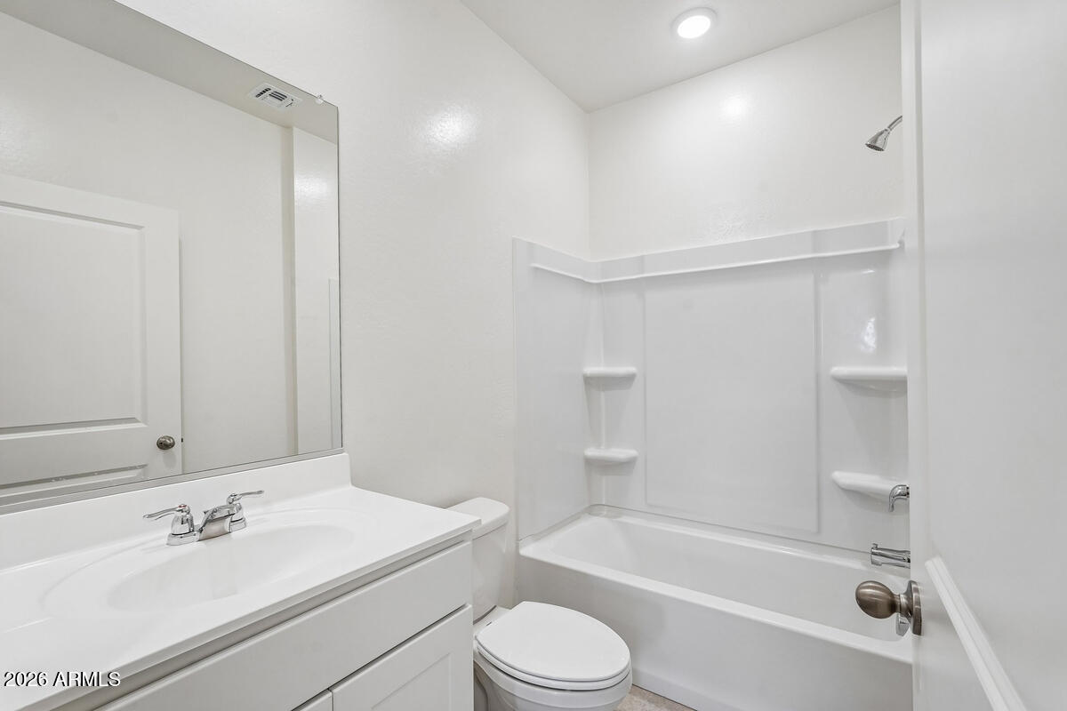 31690 Rodeo Road San Tan Valley, AZ 85140 - Photo 13 of 35 a bathroom with a bathtub shower sink vanity mirror and toilet