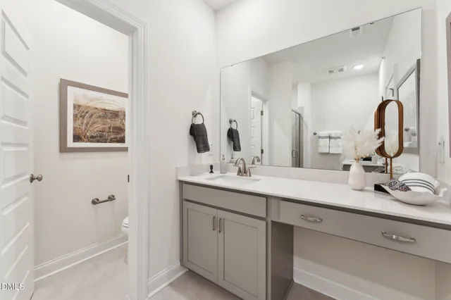 a bathroom with a double vanity sink and a mirror