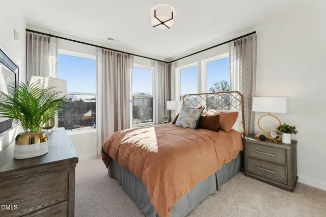 a bed room with a bed and potted plant