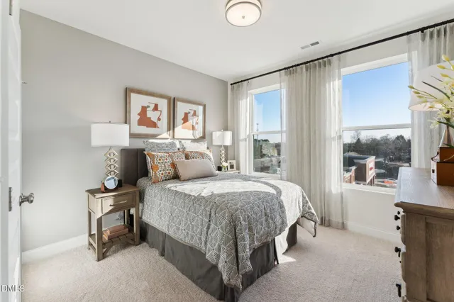 a bed room with a bed and a painting on the wall