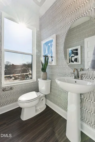 a bathroom with a sink toilet and a window