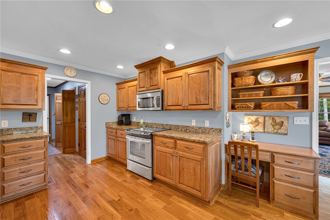 1010 Ridgeview Drive Pendleton, SC 29670 - Photo 16 of 47 Warm wood cabinetry, sleek stainless steel appliances, and gleaming hardwood floors define this inviting kitchen space.