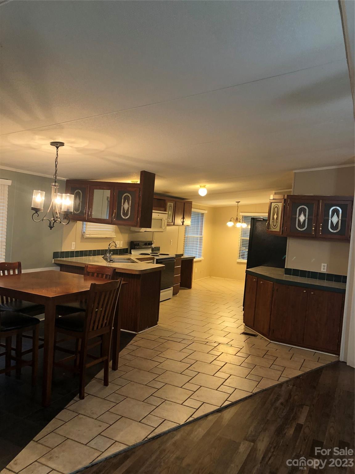 1417 Woodridge Road, Unit 31 Clover, SC 29710 - Photo 9 of 22 a kitchen with stainless steel appliances kitchen island granite countertop a refrigerator a stove a sink and a counter space