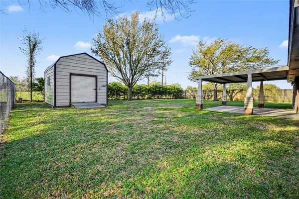 a view of a house with yard and a garden
