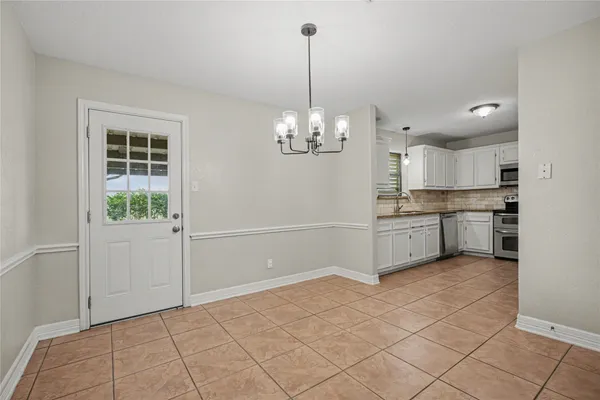 a view of a kitchen with microwave and cabinets