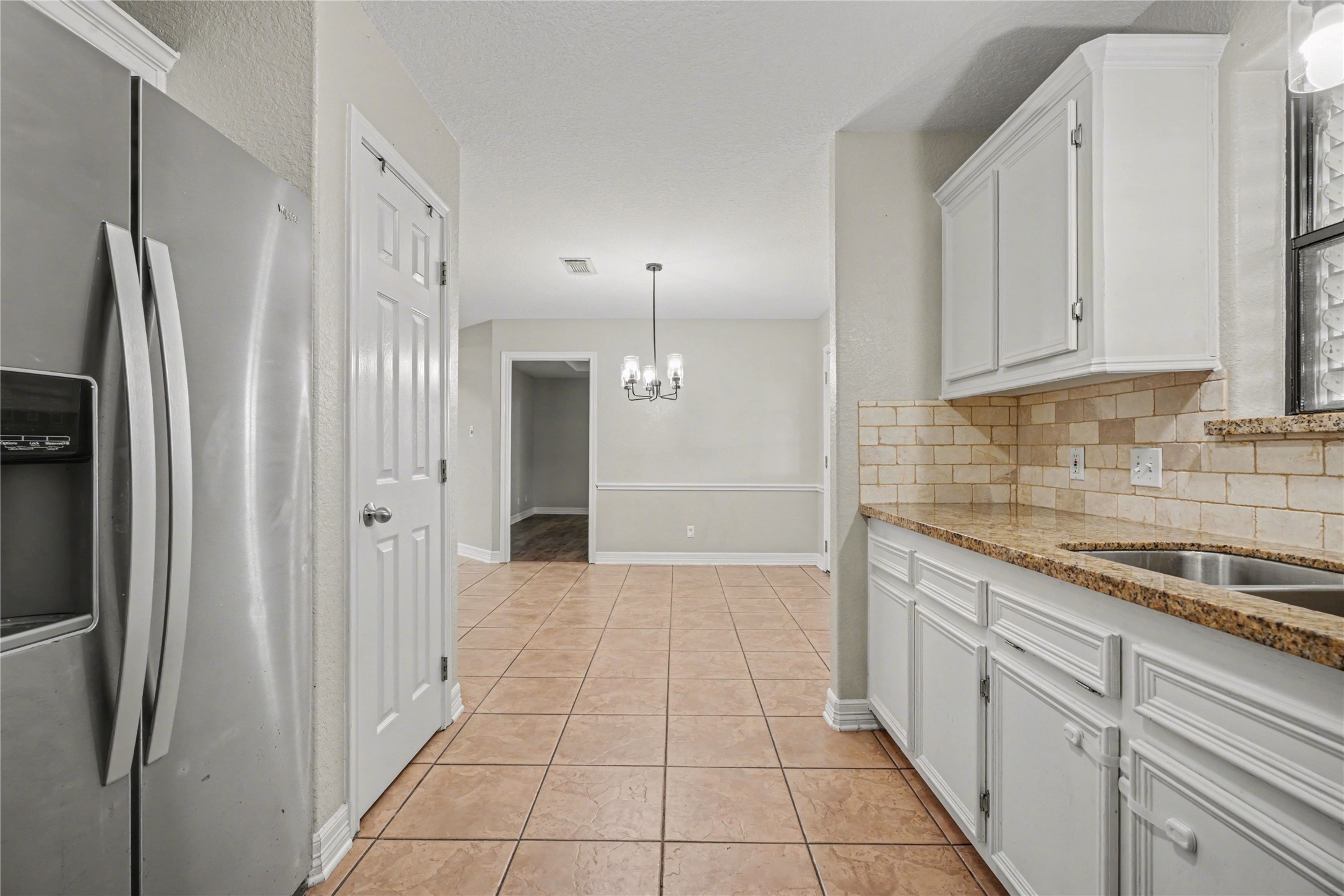 12431 9th Street Santa Fe, TX 77510 - Photo 7 of 18 a kitchen with stainless steel appliances granite countertop a refrigerator and a sink