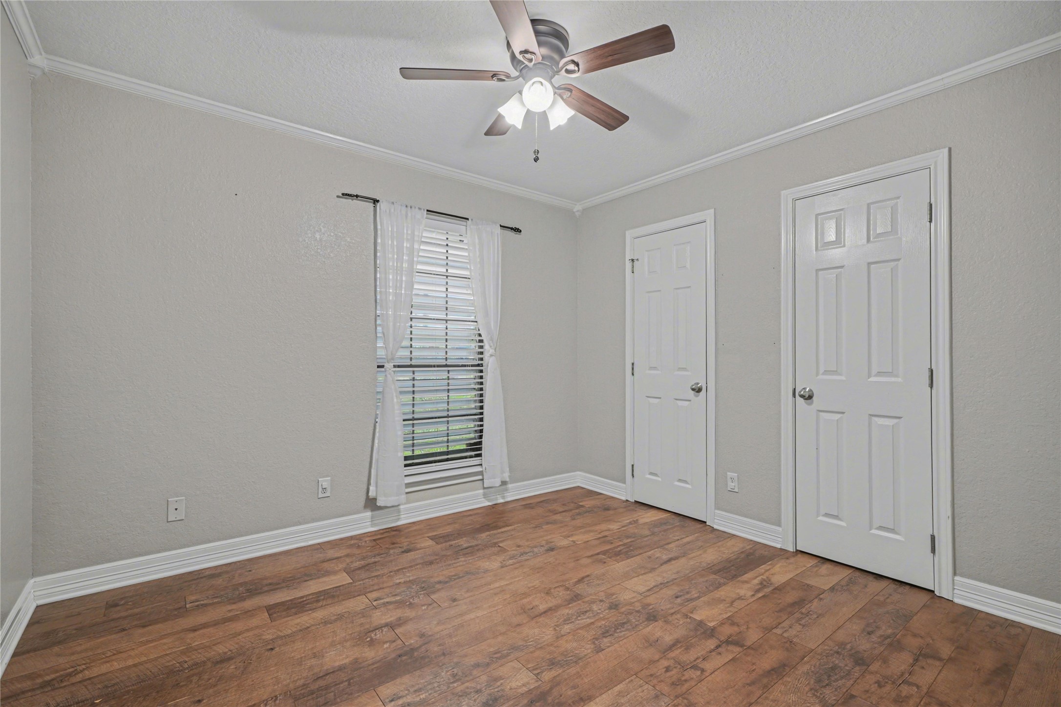12431 9th Street Santa Fe, TX 77510 - Photo 10 of 18 a view of empty room with window and ceiling fan