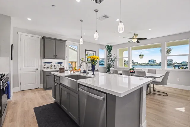 a kitchen with a sink and chairs