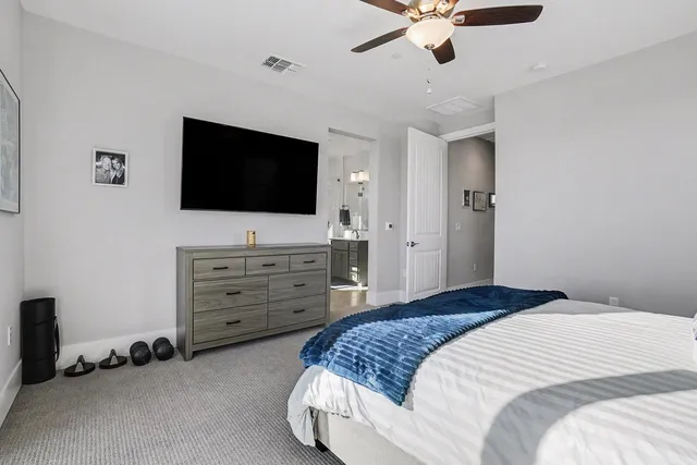 a spacious bathroom with a double vanity sink mirror and bathtub